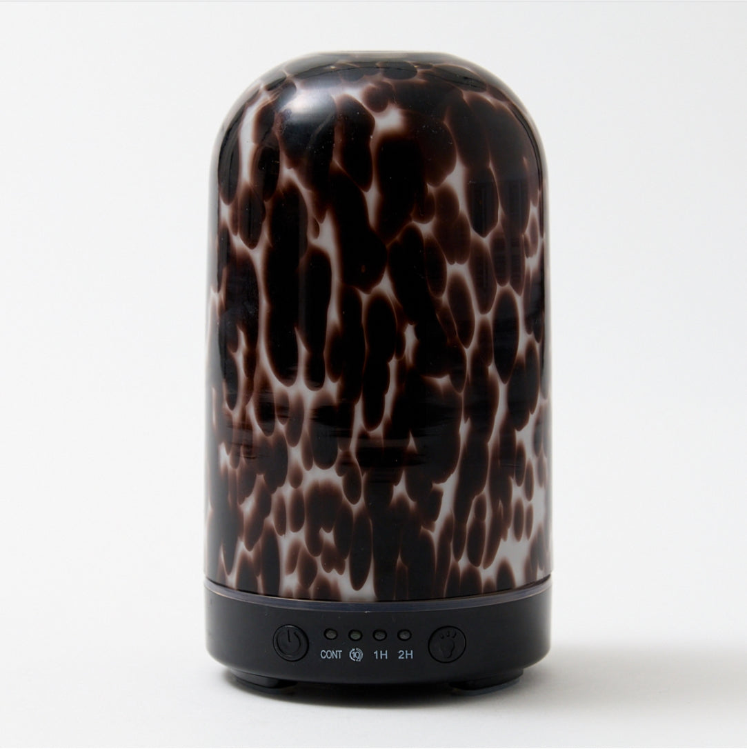 Brown tortoiseshell electronic diffuser on a white background