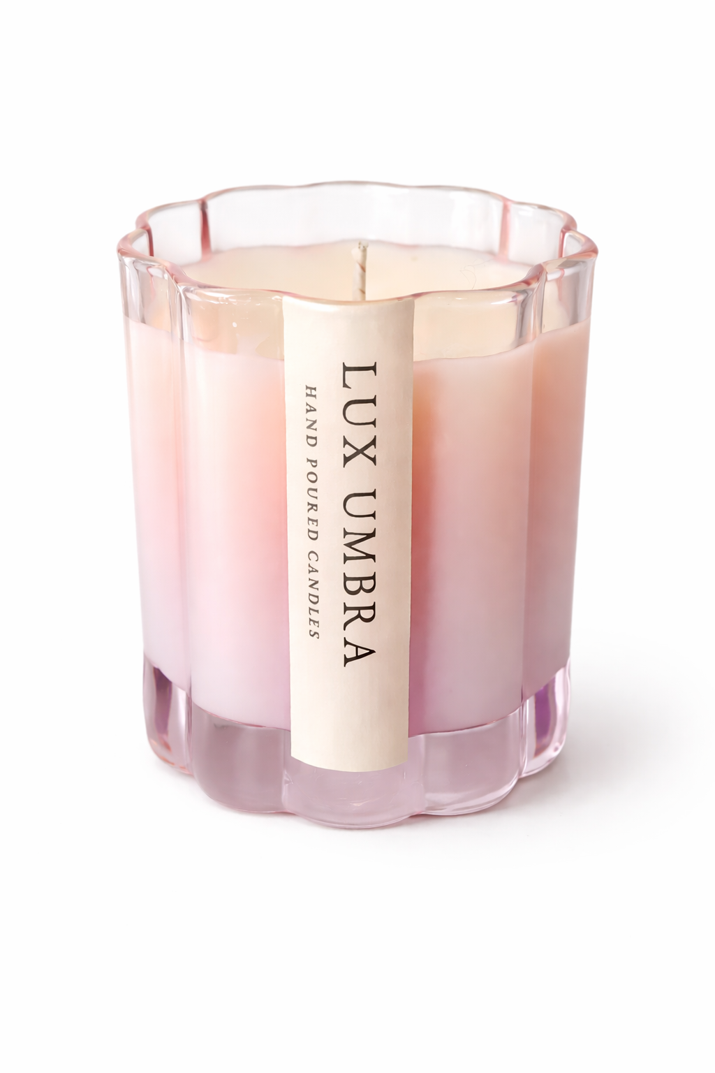 Pink candle with 'Lux Umbra' label on a white background