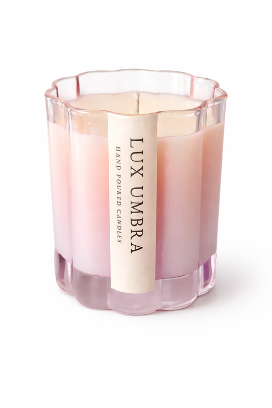 Pink candle with 'Lux Umbra' label on a white background