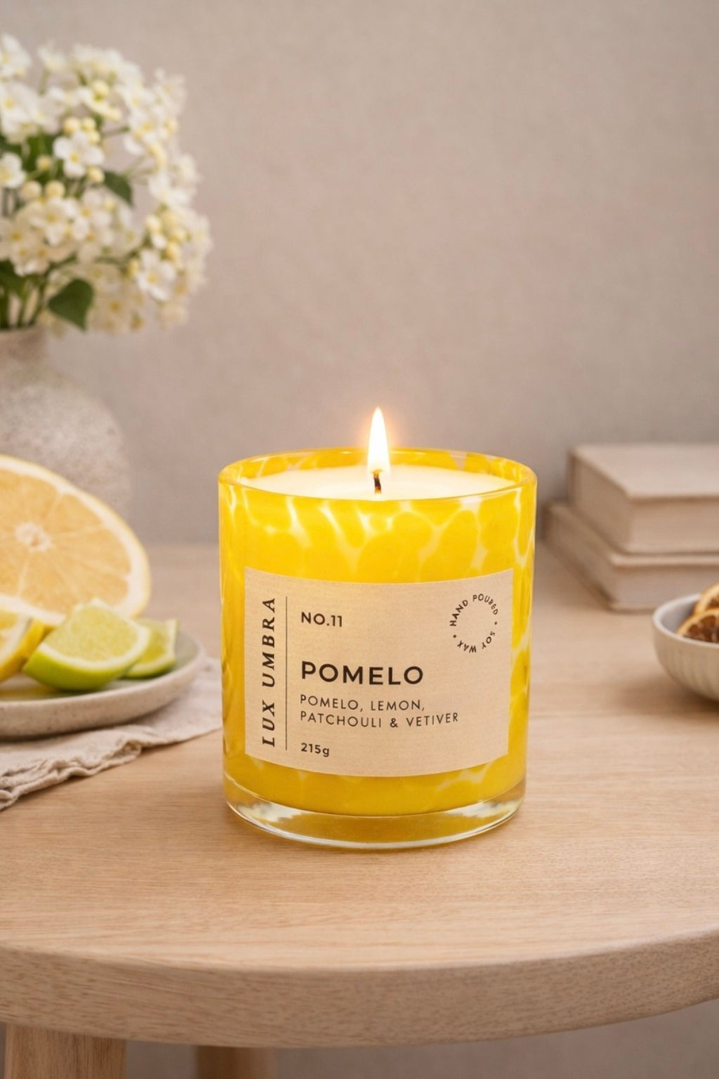 A yellow tortoiseshell candle called Pomelo, sitting on a table