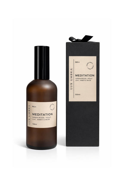A bottle of 'Meditation' room spray fragrance by Lux Umbra with its packaging on a white background.