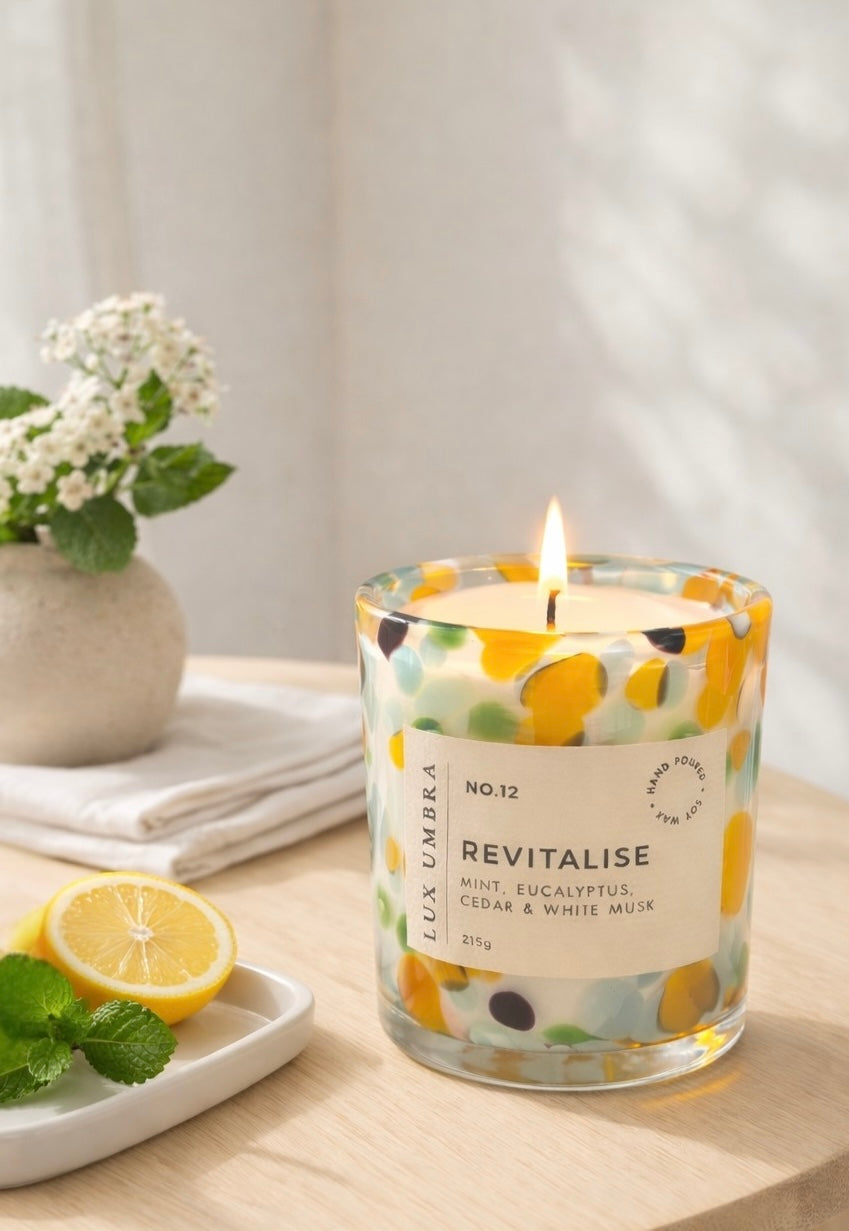 Multicoloured tortoiseshell candle called revitalise, sitting in a table